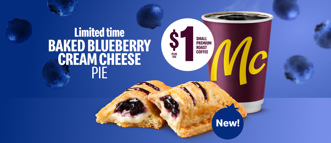 A halved Baked Blueberry Cream Cheese Pie sits against a blue background next to a McCafé cup.