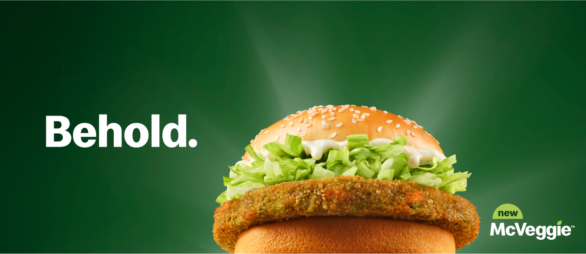 A McVeggie™ with the word ‘Behold’ on the left of it and the words ‘new’ ‘McVeggie™’ beside it on the right. 