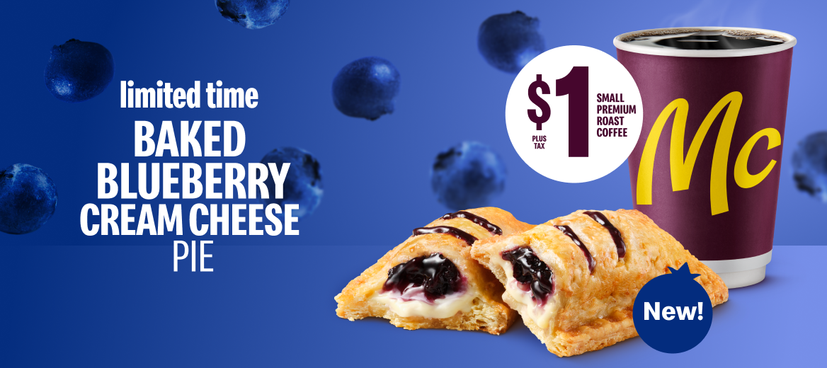 A halved Baked Blueberry Cream Cheese Pie sits against a blue background next to a McCafé cup.