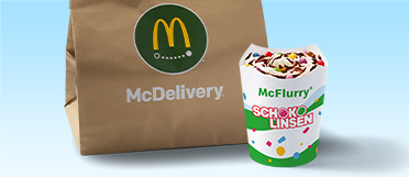 McFlurry® Original mit Schokolinsen und Schoko-Sauce, daneben eine McDelivery® Tüte