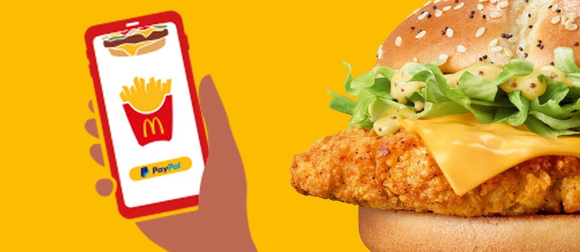 Bild zeigt den neuen McCrispy® und ein Smartphone als Hinweis für Mobile-Order-and-Pay.