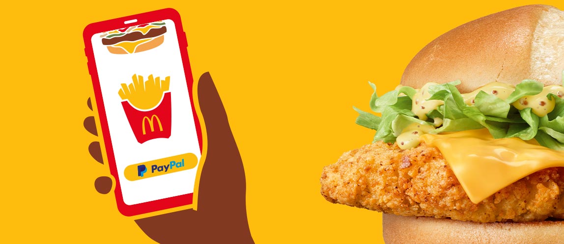 Bild zeigt den McCrispy® und ein Smartphone als Hinweis für Mobile-Order-and-Pay.