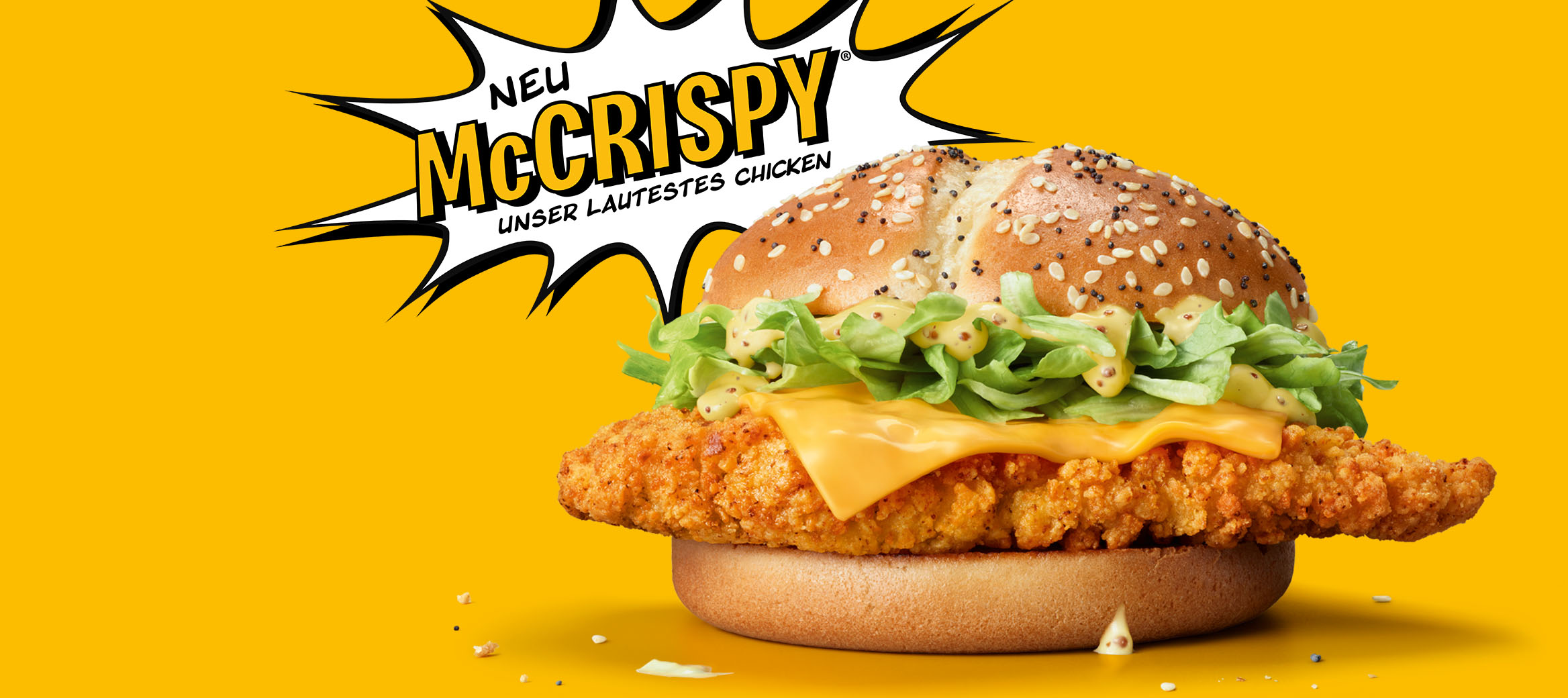 Bild zeigt den neuen McCrispy®: goldbraunes Bun und ein Hähnchenbrustfiletstück in Crispy-Panade.