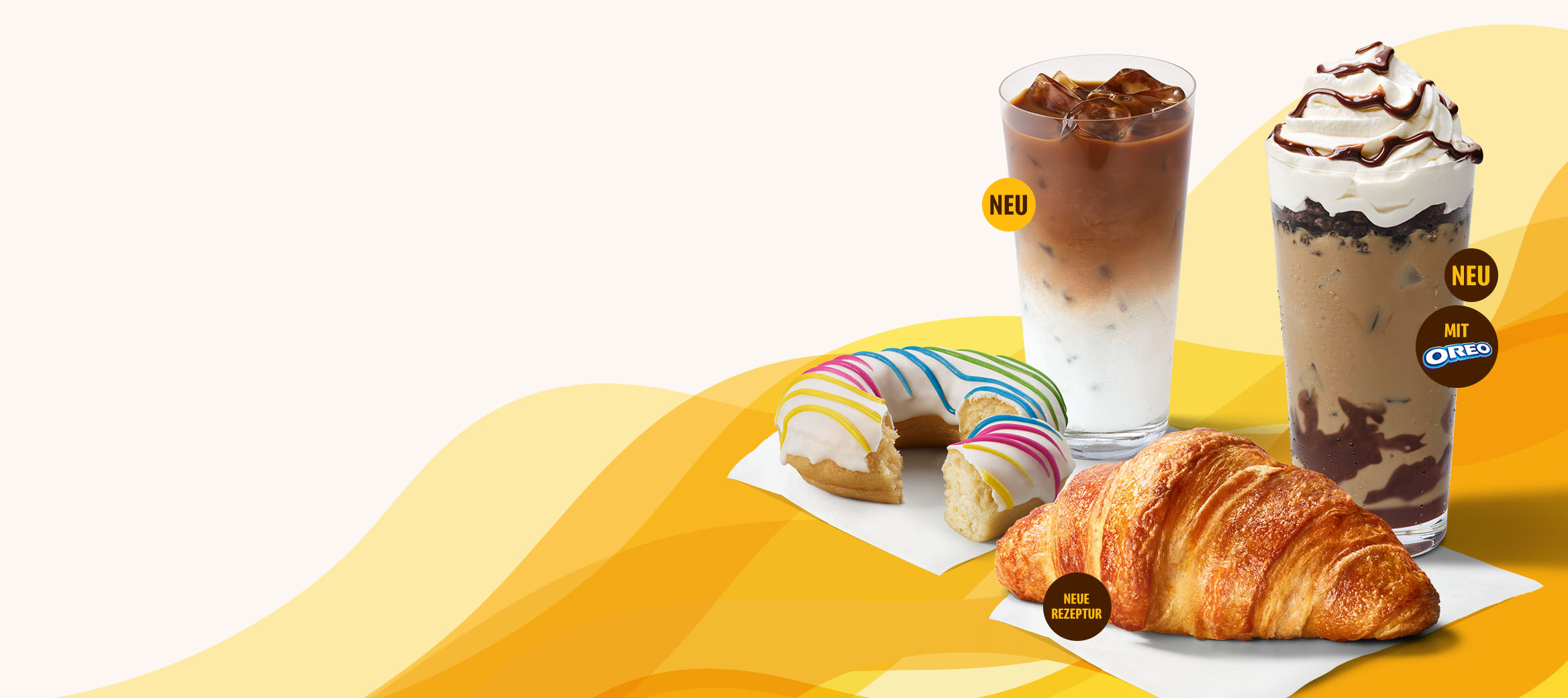Buttercroissant, Rainbow Donut, Iced Latte und Iced Coffee Shake Choc OREO®