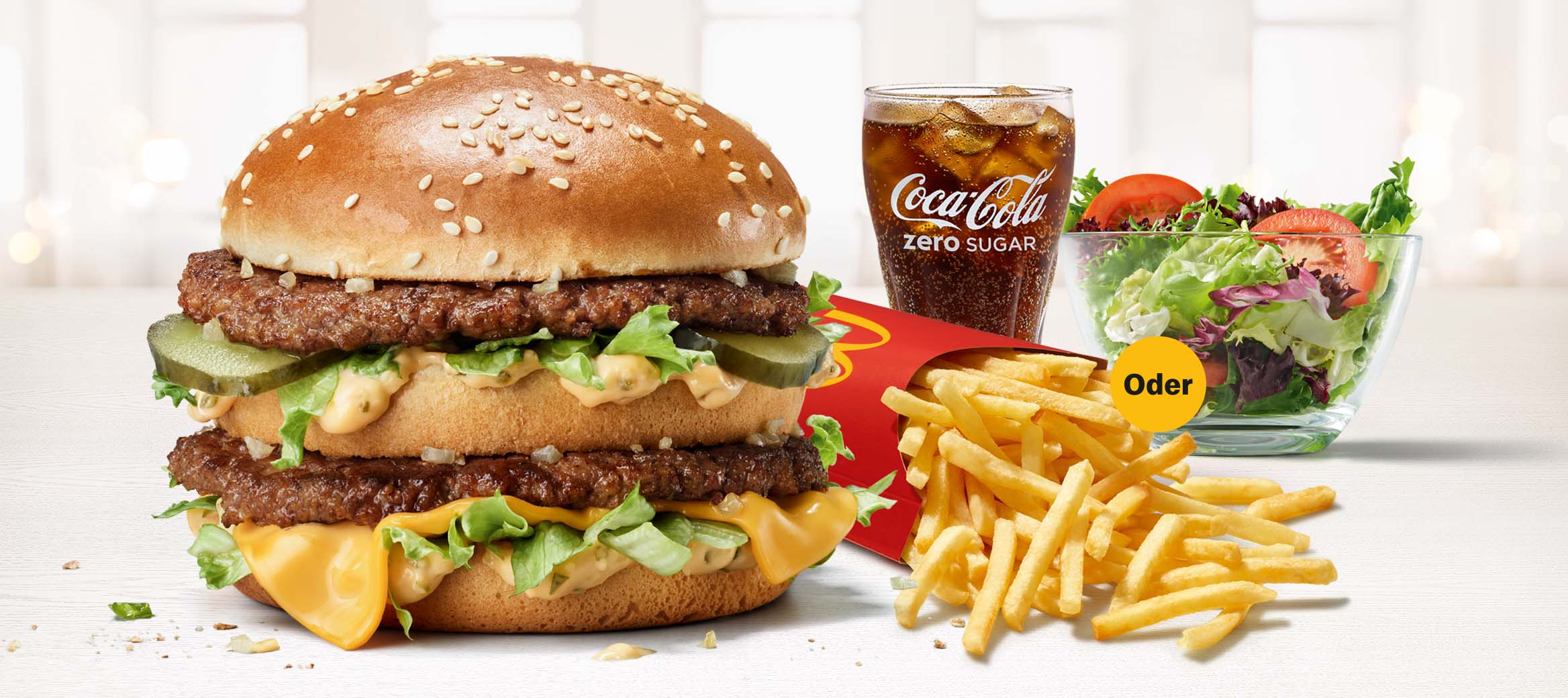 Abbildung des McMenü® mit Big Mac, große Pommes oder Snack Salad, großer Coca-Cola.