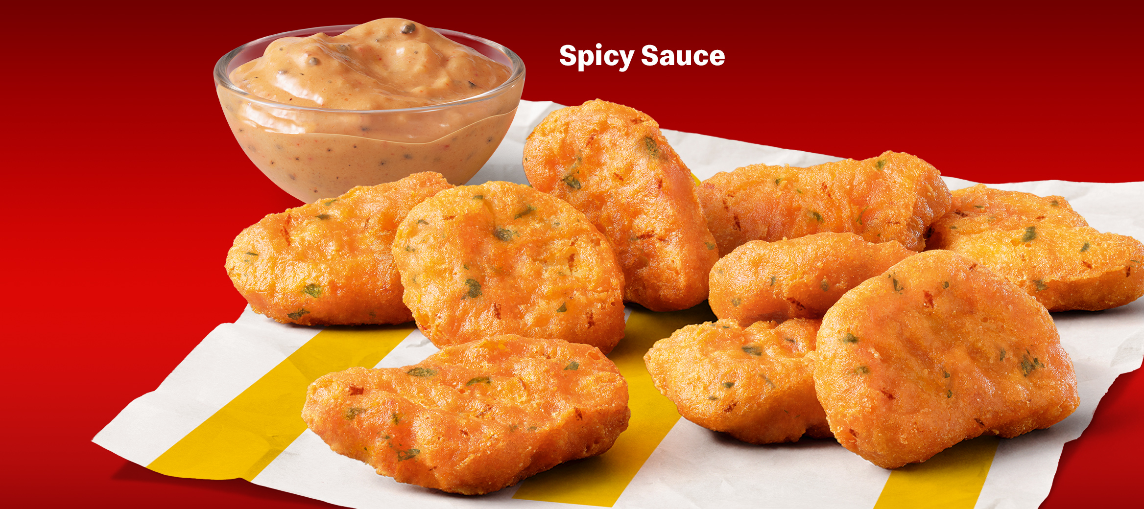 Abgebildet sind die Spicy Chicken McNuggets® mit Spicy Sauce.