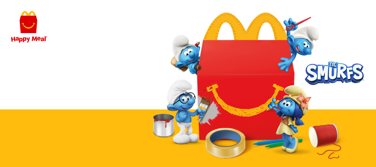 Happy Meal box with four Smurfs doing arts and crafts.