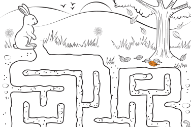 A rabbit on a maze with a tree and leaves. 