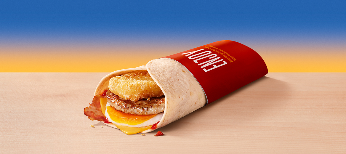 A McDonald’s breakfast wrap on a blue-orange gradient background.