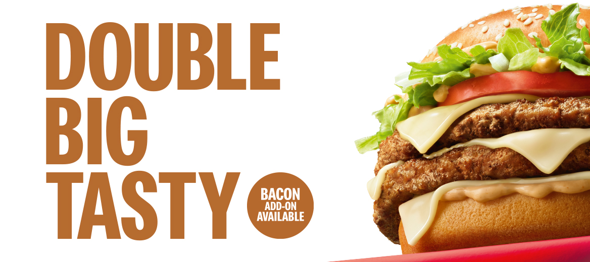 The double big tasty on a red platform in the corner on a white background with “Double Big Tasty. Bacon add-on available” next to it. 