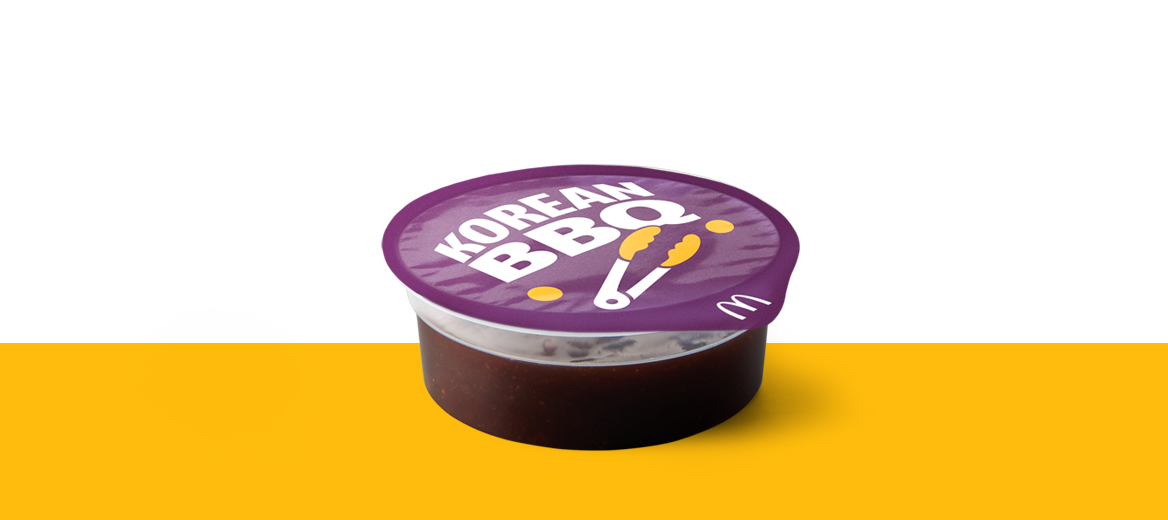 Pot of Korean BBQ dipping sauce with branded purple lid.