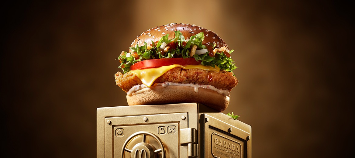 McDonald’s Maple & Cheddar Chicken sits on top of a gold vault. 