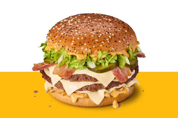 Big Arch burger with two beef patties, cheese slices, bacon, lettuce and pickles in a poppy and sesame seed bun