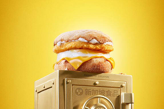 McDonald’s Chicken & Egg McMuffin® sits on top of a gold vault .