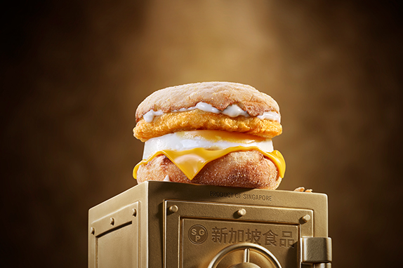 McDonald’s Chicken & Egg McMuffin® sits on top of a gold vault .