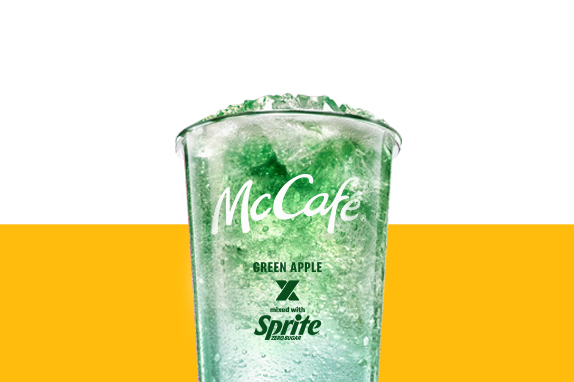 : Iced Green Apple x Sprite Zero drink in a clear McCafé cup with a green gradient effect.