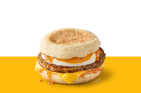 Sausage and egg McMuffin topped with melted cheese and Hot Honey sauce.