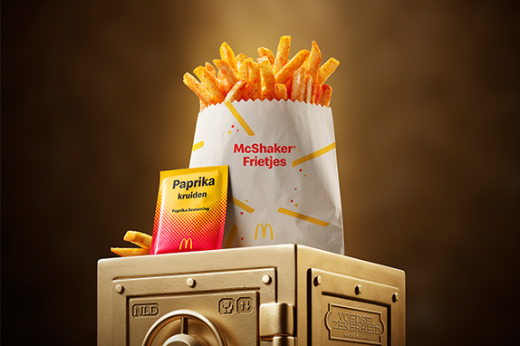 McDonald’s Paprika McShaker® Fries sits on top of a gold vault .