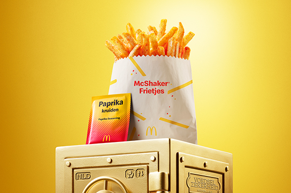 McDonald’s Paprika McShaker® Fries sits on top of a gold vault.