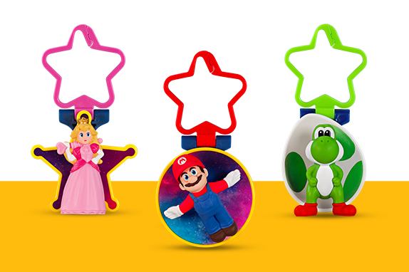 Super Mario and Yoshi on a circular toy that has a star on top of the toy. Princess Peach on a star toy that has a star on top of the toy 