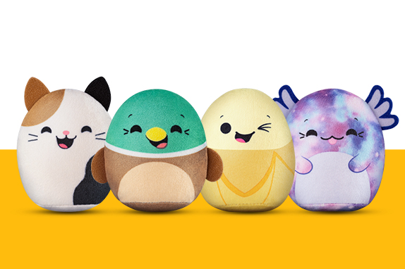 Four Squishmallows characters on a yellow shelf  