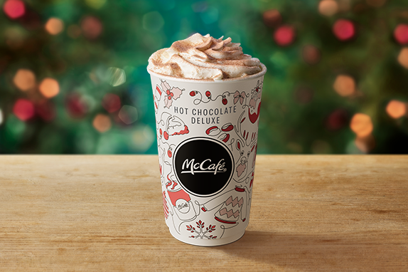 Hot Chocolate Deluxe on a table with a Christmas background.
