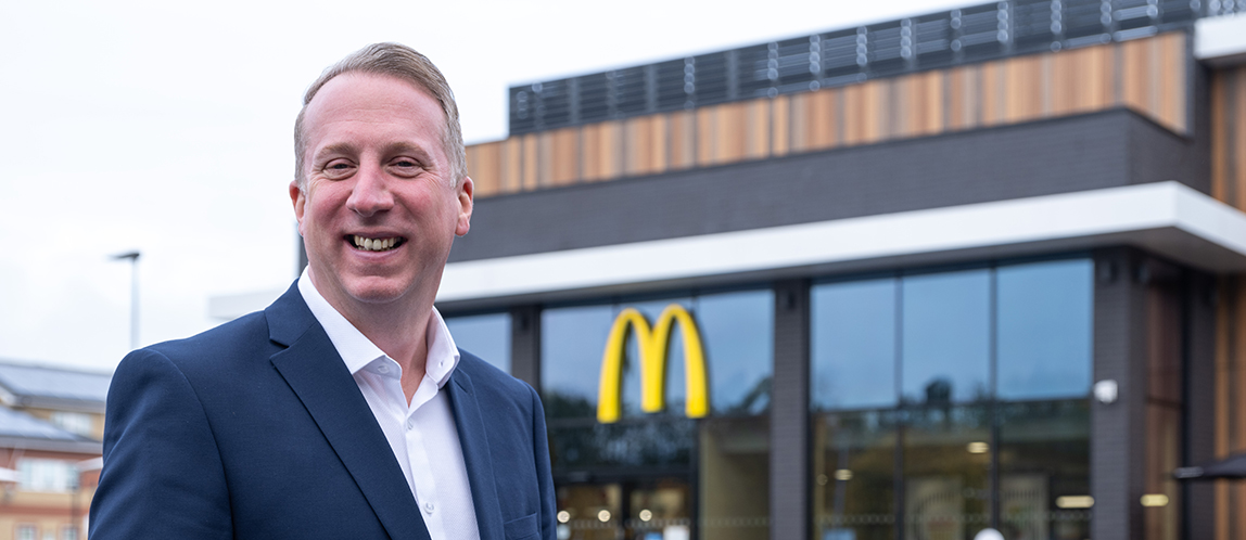 McDonald’s Restaurant Owner holding a coffee in the dining area.