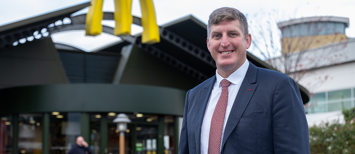 McDonald’s Restaurant Owner outside a restaurant beneath the Golden Arches.