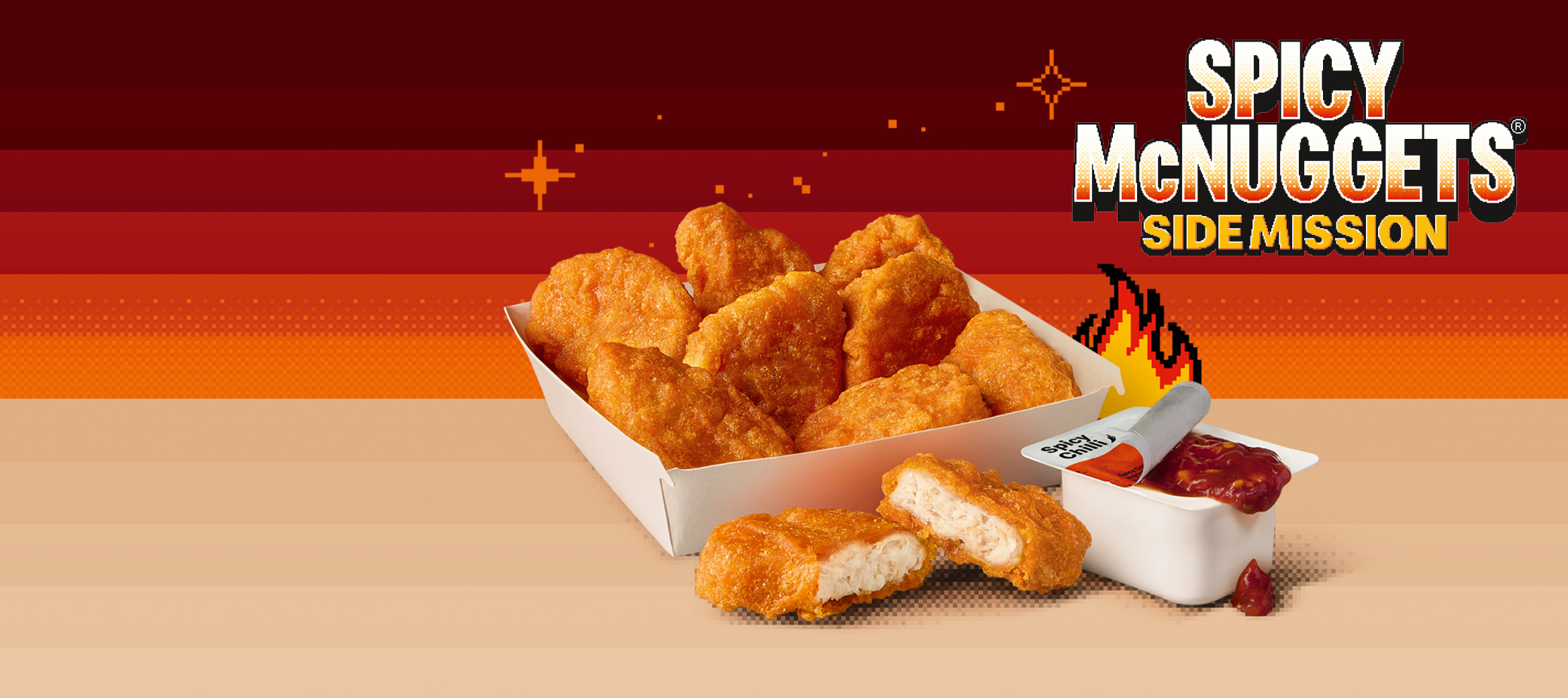 Spicy Chicken McNuggets and Spicy Chilli Dip on a brown shelf against a orange and red gradient pixelated background.