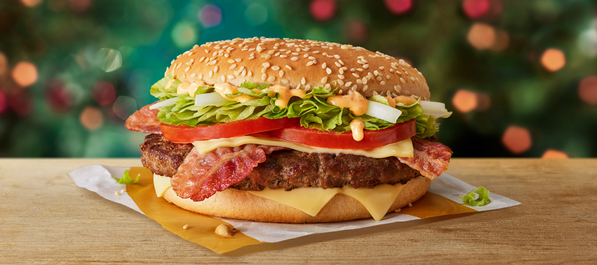 Big Tasty with Bacon on a table with a Christmas background.