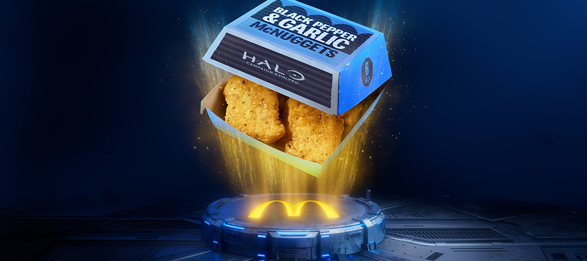 Open box of Black Pepper & Garlic McNuggets featuring Halo branding, floating above a glowing McDonald's platform. Golden McNuggets are visible inside the blue pack, illuminated by beams of light against a futuristic dark blue background.