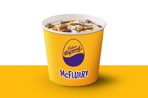 Cadbury Caramel Egg McFlurry ice cream on a yellow shelf.