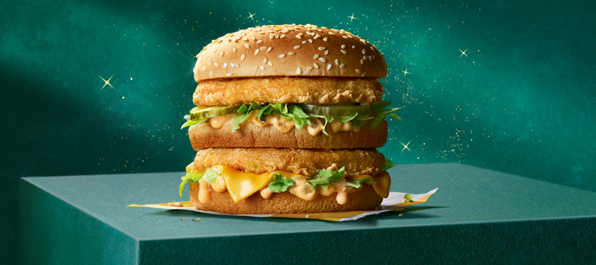 A McDonald’s chicken burger on a green plinth with a green starry background.