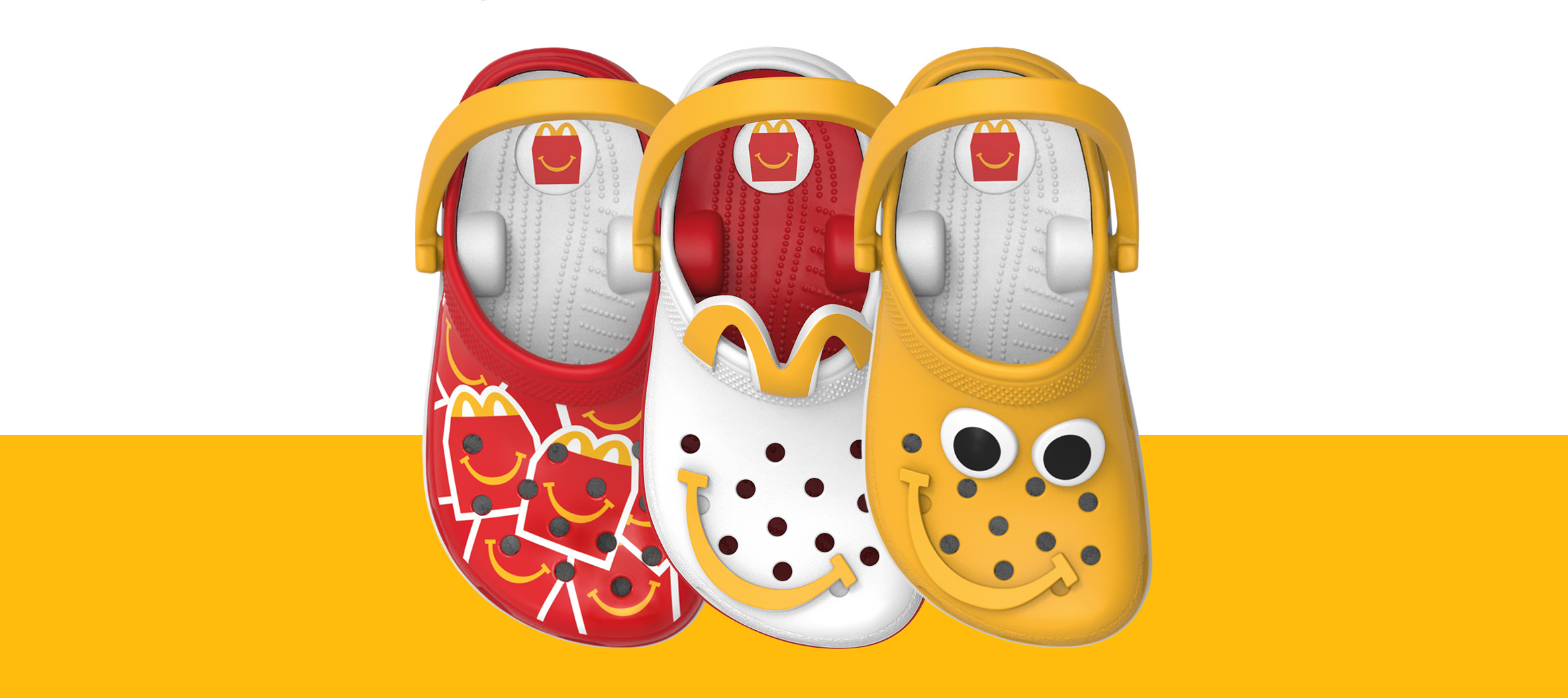 Three Crocs-themed toy clogs in red, white and yellow displayed side by side.