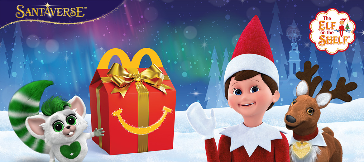 Festive winter scene with an Elf on the Shelf, a reindeer, a green-tailed bogie, and a McDonald’s Happy Meal box in snow.