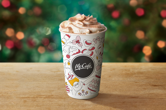 Hot Chocolate Deluxe on a table with a Christmas background. 
