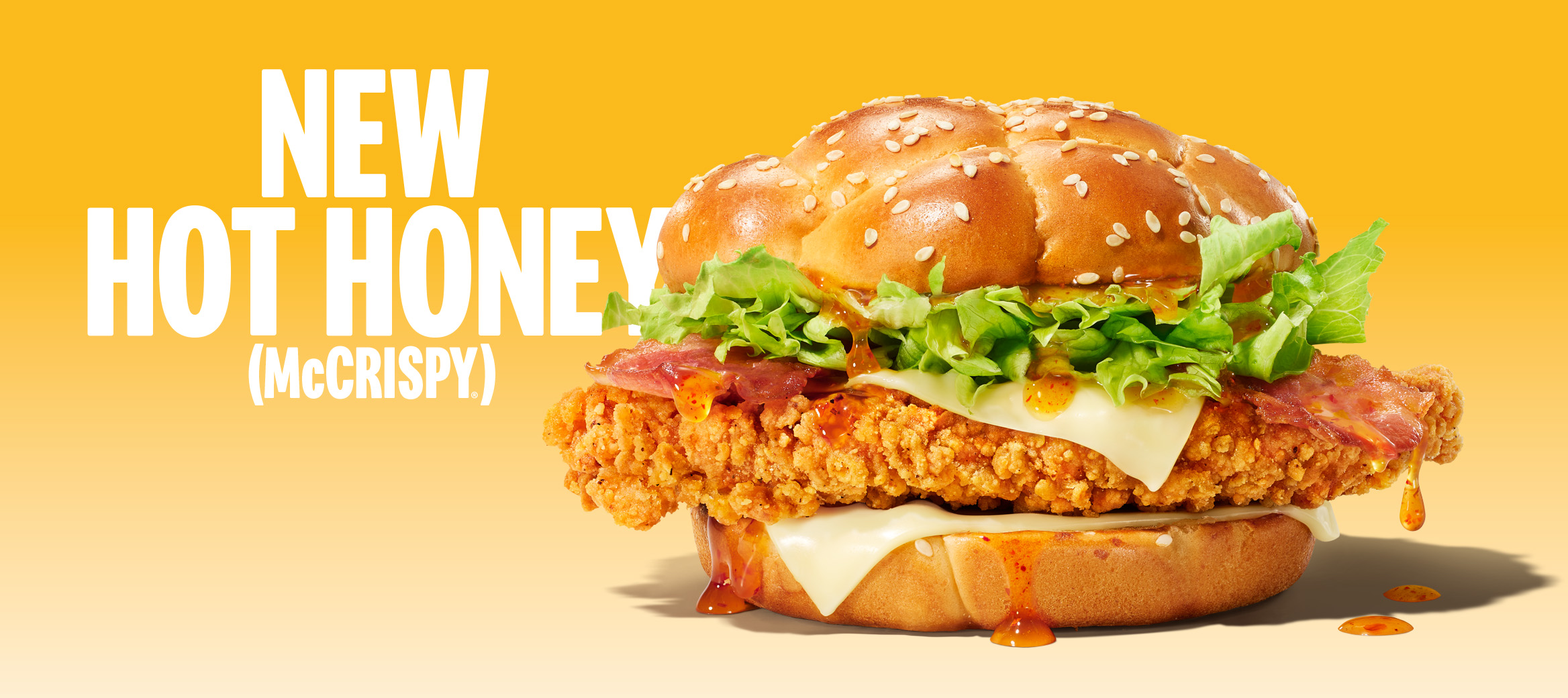 Hot Honey McCrispy burger with promotional text on a yellow grad background.