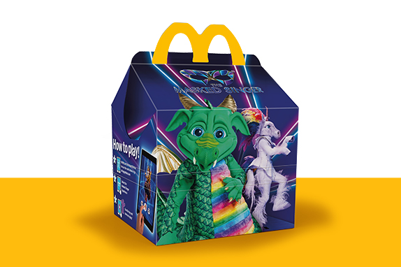 The Masked Singer themed Happy Meal box with The Dragon and The Unicorn.