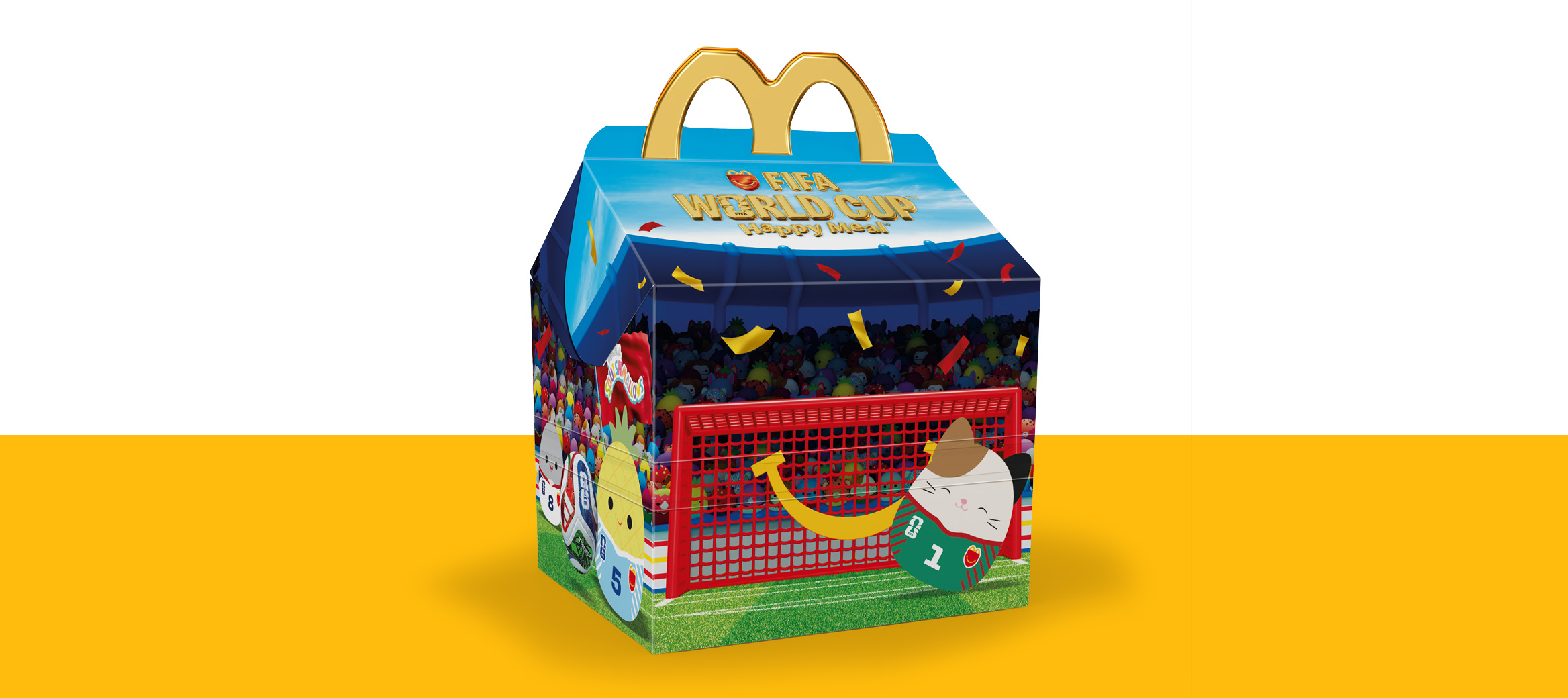 McDonald’s Happy Meal box designed like a football stadium, filled with colourful Squishmallows characters and a goal on the front.