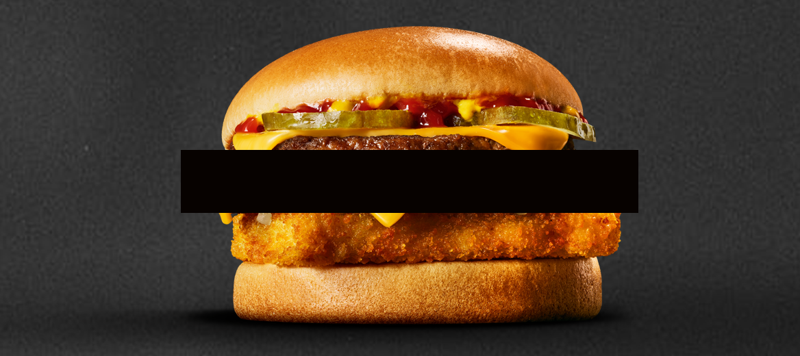 Image of the McDonald’s Surf N Turf burger on a black background.