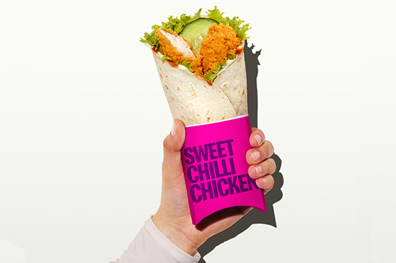 The Sweet Chilli Chicken One wrap against a pink background.