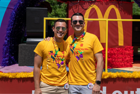 Two men in front of a McDonald’s parade float